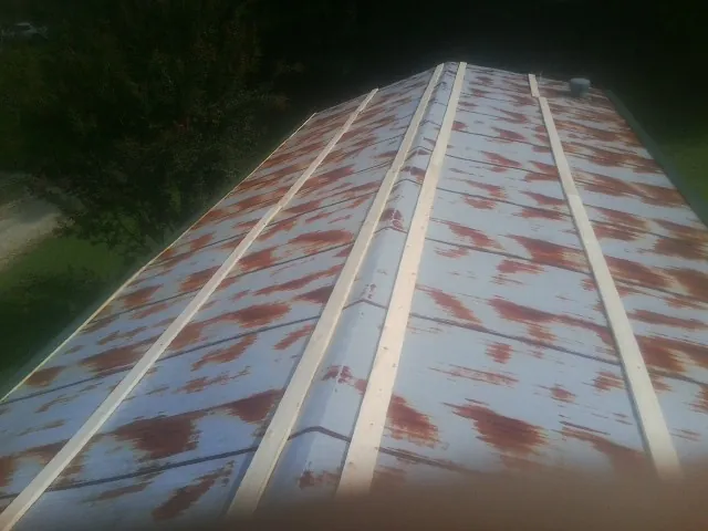 Rusted metal roof panels with new wood purlins before replacement — Storm Damage Roof Repair in Pewee Valley by Roofing Brothers